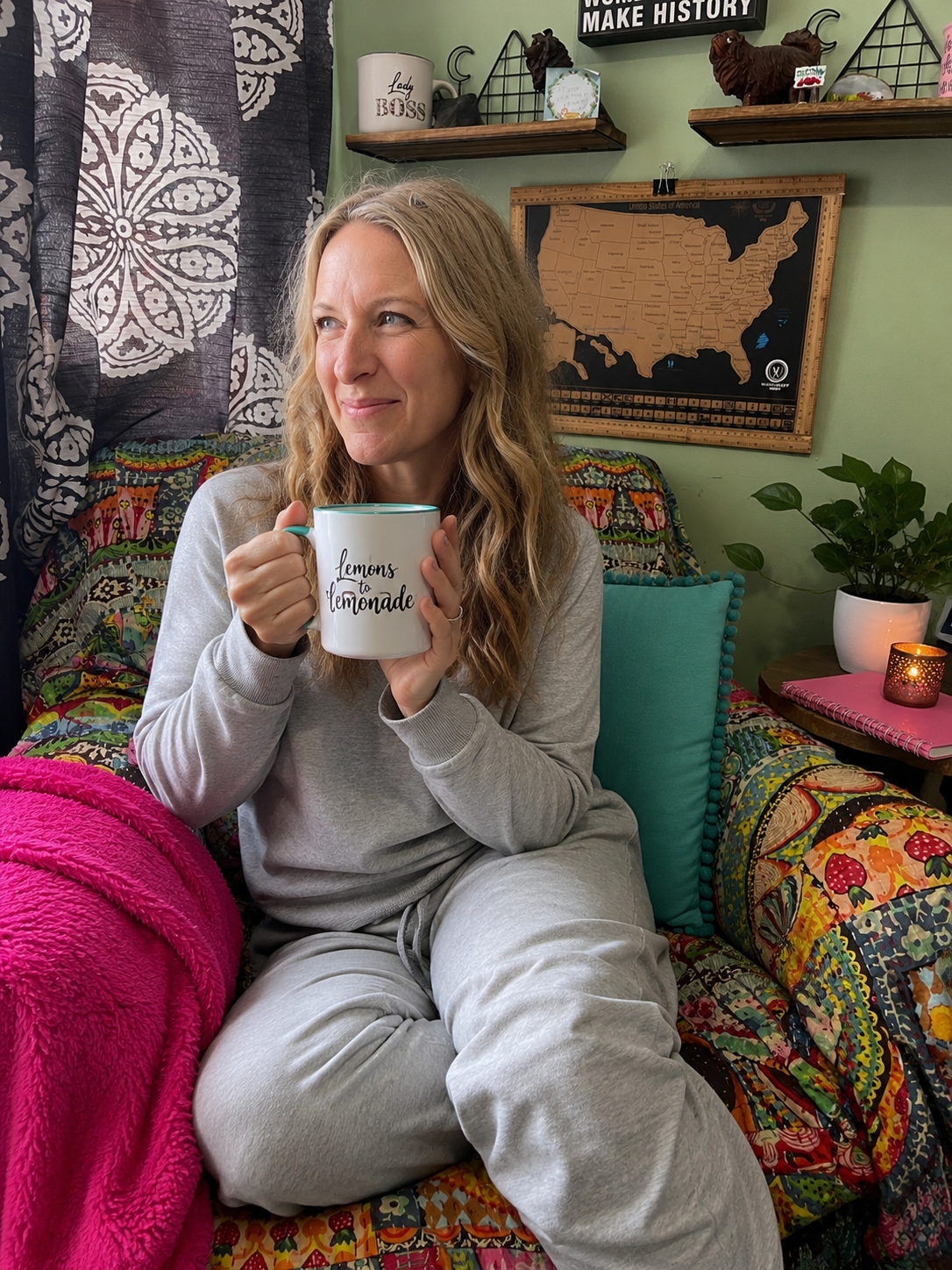 Lizzy Joy with a mug of tea from a UGC video, in her office chair.