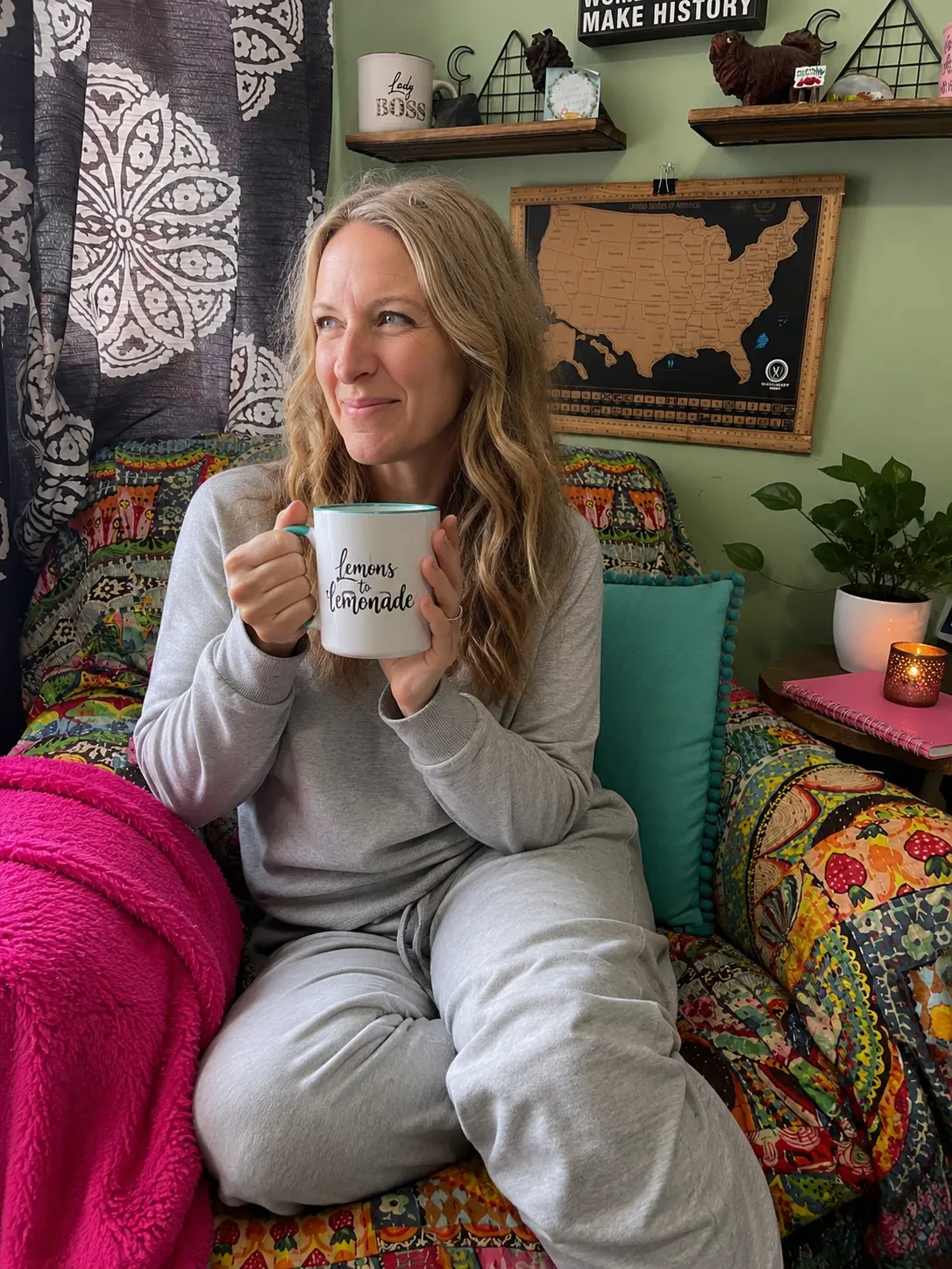 Lizzy Joy with a mug of tea from a UGC video, in her office chair.
