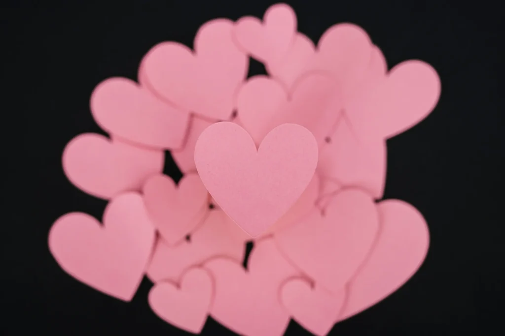 Several pink hearts combine together in a pile.